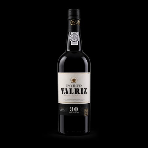 Bottle of Noval Valriz 30 year old tawny port wine with black label on dark background