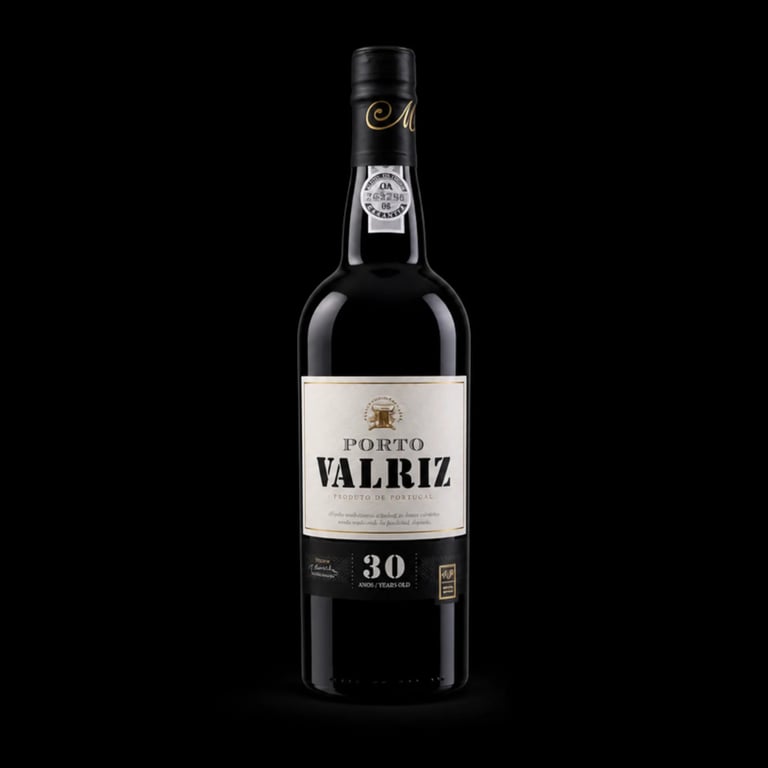 Bottle of Noval Valriz 30 year old tawny port wine with black label on dark background