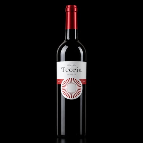 Bottle of Douro Teoria red wine with red cap and white label featuring a circular sunburst design