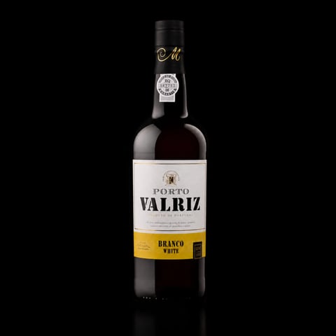 Bottle of Porto Valriz white port wine against a black background