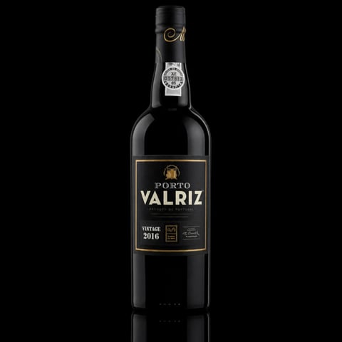Bottle of Porto Valriz vintage 2016 red wine against black background with reflection