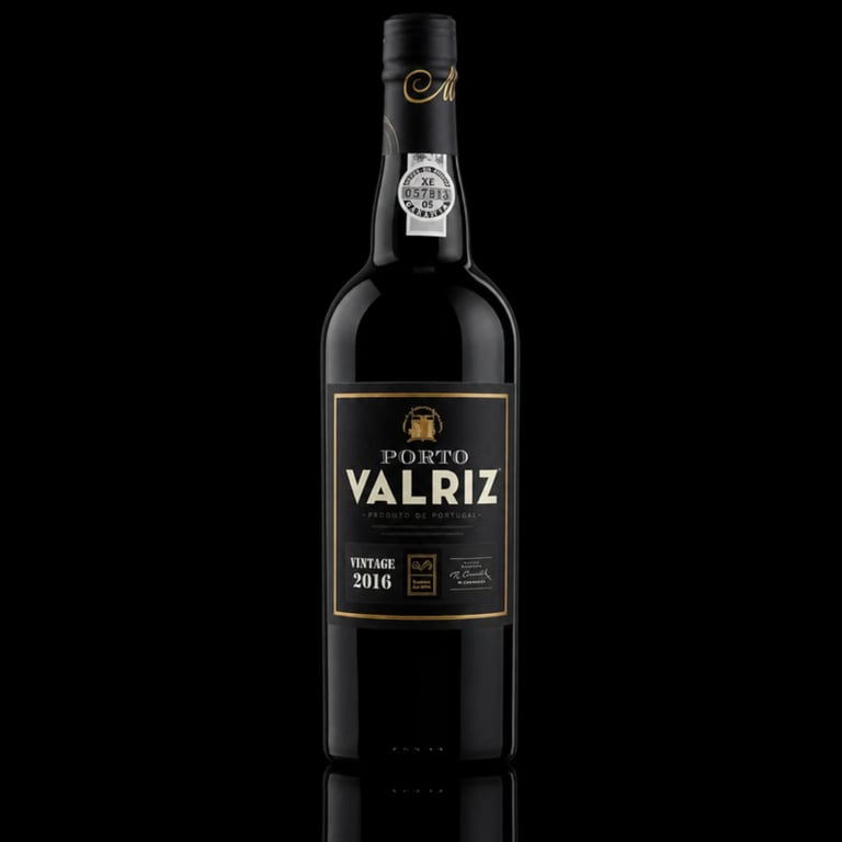 Bottle of Porto Valriz vintage 2016 red wine against black background with reflection