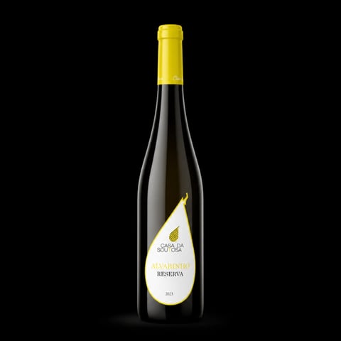 Bottle of Casal da Couta Reserva wine with yellow capsule and teardrop label on black background